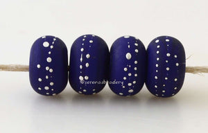 DARK COBALT BLUE with Fine Silver Dots Dark cobalt blue decorated with fine silver dots or nailheads. The silver sire has been carefully burnished onto the glass bead while it is still hot to ensure that it has permanently adhered to the bead. These are shown in a matte finish, but can also be ordered glossy.~~~~~~~~~~~~~~~~~~~~~~~~~~6x11, 12 or 7x13 mm4 Beads2.5 mm hole Glossy,11 mm,Glossy,12 mm,Glossy,13 mm,Matte,11 mm,Matte,12 mm,Matte,13 mm
