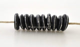 Black Mini Fine Silver Dot Wavy Disks A set of 10 black glass lampwork disks with wraps of fine silver dots in a mini size.~~~~~~~~~~~~~~~~~~~~~~~~~~3x10-11 mm10 Beads1.5 mm hole Glossy,Matte