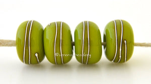 4 Green Pistachio Fine Silver Wire Wraps Rustic pistachio green lampwork glass beads with fine silver wire wraps. Available in glossy or matte.~~~~~~~~~~~~~~~~~~~~~~~~~~6x11, 12 or 7x13 mm4 Beads2.5 mm hole Glossy,11 mm,Glossy,12 mm,Glossy,13 mm,Matte,11 mm,Matte,12 mm,Matte,13 mm