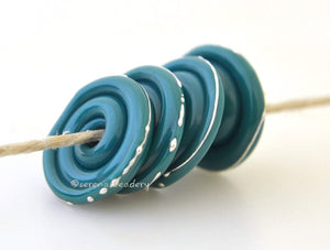 Mermaid TEAL GREEN Wavy Disks A set of 4 teal green glass lampwork disks with fine silver wire.~~~~~~~~~~~~~~~~~~~~~~~~~~3x14 mm4 Beads2.5 mm hole Glossy,Matte