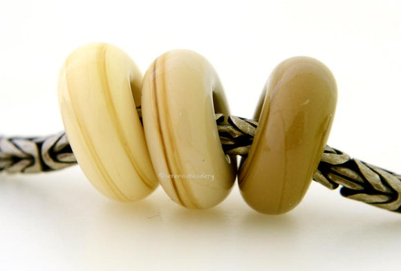 Boho Chic Trio Euro Charm Set A trio of European charm bracelet beads in ivory, sandstone, and sage.These lampwork beads will fit your European charm style bracelet.7x13-14 mm3 Beads5 mm holeprice is per bead set Glossy,Matte