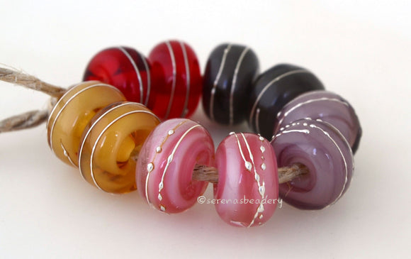 Mellow Mystics A set of mellow mystic lampwork beads with 5 different pairs - red, grey, violet, pink, and beige. Each silver wrap is carefully burnished onto the glass bead while it is still hot. Bead Size: 6x11 mm Amount: 10 Beads Hole Size: 2.5 mm Also available in a 7x14 mm size for .00 extra. Glossy,6x11mm,Glossy,7x14mm,Matte,6x11mm,Matte,7x14mm