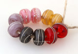 Mellow Mystics A set of mellow mystic lampwork beads with 5 different pairs - red, grey, violet, pink, and beige. Each silver wrap is carefully burnished onto the glass bead while it is still hot. Bead Size: 6x11 mm Amount: 10 Beads Hole Size: 2.5 mm Also available in a 7x14 mm size for .00 extra. Glossy,6x11mm,Glossy,7x14mm,Matte,6x11mm,Matte,7x14mm