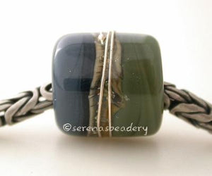Olive Steel European Charm with Fine Silver One european charm style bracelet bead with olive green and steel blue, silvered ivory, and fine silver.Bead Size: approximately 12x11 mmAmount: 1 BeadHole Size: 5 mm Glossy,Matte