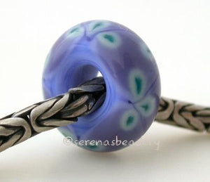 Periwinkle Lilac and Green Flower European Charm One periwinkle blue and lilac purple bead with copper green flowers and a hole large enough for a european charm bracelet. Will also fit your biaga or troll bracelet. Silver bracelet is not included.Bead Size:7x15 mmAmount:1 BeadHole Size:5 mm Glossy,Matte
