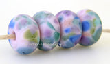 Dainty Furbelow LTD Bubble gum pink lampwork glass beads with purple, peach, blue, and green frit. Bead Size: 6x12 mm Hole Size: 2.5 mm Glossy,Matte