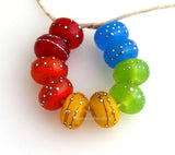 Assorted Popsicles A set of 5 pairs in red, orange, yellow, green and blue. Ive chosen the brightest neon shades of each color that I could find in my stock. This fun rainbow assortment is similar to an assorted pack of popsicles. Each silver wrap is carefully burnished onto the glass bead while it is still hot. Bead Size: 6x11 mm Amount: 10 Beads Hole Size: 2.5 mm Also available in a 7x14 mm size for .00 extra. Glossy,6x11mm,Glossy,7x14mm,Matte,6x11mm,Matte,7x14mm