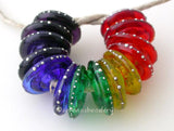 Rainbow Silver Wrapped Wavy Disc Set A set of rainbow wavy disk pairs wrapped in fine silver. The colors range from red, orange, yellow, green, blue, indigo, and violet. 3x14mm price is per set of 14 beads Glossy,Matte