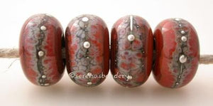 Red Rock Granite with Fine Silver Red Rock wrapped in silvered ivory and fine silver droplets. 5x11 mm 2.5 mm hole Price is per bead with discounts for larger quantities. Glossy,Matte