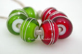Green & Red Fine Silver Wraps A set of dark grass green and red white heart bead wrapped with strands of fine silver. 6x12 mm price is per 8 bead set Glossy,Matte