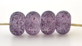 Royal Reflections Crystal clear lampwork glass beads with tiny bits of purple frit.Bead Size: 6x11-12 or 7x13-14 mmHole Size: 2.5 mmprice is for one bead with a discount for 4 or more 11-12 mm,Glossy,13-14 mm,Glossy,11-12 mm,Matte,13-14 mm,Matte