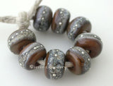 Tamarind Granite with Fine Silver Tamarind brown wrapped in silvered ivory and fine silver droplets. 5x11 mm 2.5 mm hole Price is per bead with discounts for larger quantities. Glossy,Matte