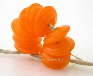 Translucent Orange Wavy Disk Spacer wavy disks in tanslucent orange2 sizes available: 11-12 mm with 1.5 mm hole or 13-14 mm with 2.5 mm holeprice is per 1 disk 11-12 mm 1.5 mm hole,12-13 mm 2.5 mm hole