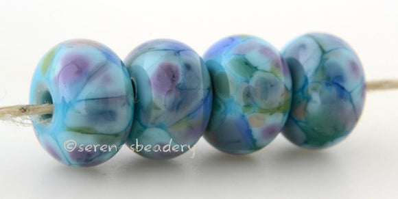 Fairly Demure LTD Light turquoise lampwork glass beads with purple, peach, blue, and green frit. Bead Size: 6x12 mm Hole Size: 2.5 mm     Glossy,Matte