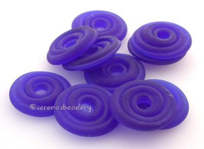 Transparent Cobalt Matte Wavy Disk Spacer  10 wavy disks in transparent cobalt matte2 sizes available: 11-12 mm with 1.5 mm hole or 13-14 mm with 2.5 mm holeprice is per 10 disks 11-12 mm 1.5 mm hole,12-13 mm 2.5 mm hole