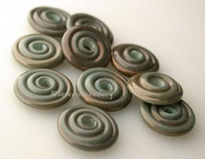 Dirty Copper Green Wavy Disk Spacer 10 wavy disks in dirty copper green2 sizes available: 11-12 mm with 1.5 mm hole or 13-14 mm with 2.5 mm holeprice is per 10 disks 11-12 mm 1.5 mm hole,12-13 mm 2.5 mm hole