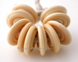 Dark Ivory Wavy Disk Spacer 10 wavy disks in dark ivory2 sizes available: 11-12 mm with 1.5 mm hole or 13-14 mm with 2.5 mm holeprice is per 10 disks 11-12 mm 1.5 mm hole,12-13 mm 2.5 mm hole