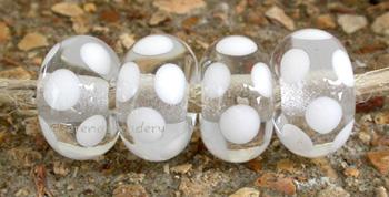 Clear White Dice Dot A clear base with white dice dots. 5x11 mm price is per bead Glossy,Matte