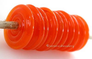 Tangerine Sparkle Wavy Disk Spacer 10 wavy disks in tangerine sparkle, an odd lot glass with glitter in a matte finish2 sizes available: 11-12 mm with 1.5 mm hole or 13-14 mm with 2.5 mm holeprice is per 10 disks 11-12 mm 1.5 mm hole,12-13 mm 2.5 mm hole