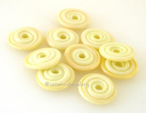 Banana Cream Wavy Disk Spacer 10 wavy disks in banana cream, an odd lot of glass2 sizes available: 11-12 mm with 1.5 mm hole or 13-14 mm with 2.5 mm holeprice is per 10 disks 11-12 mm 1.5 mm hole,12-13 mm 2.5 mm hole