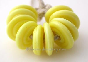Lemon Meringue Wavy Disk Spacer 10 wavy disks in lemon meringue, an odd lot of glass2 sizes available: 11-12 mm with 1.5 mm hole or 13-14 mm with 2.5 mm holeprice is per 10 disks 11-12 mm 1.5 mm hole,12-13 mm 2.5 mm hole