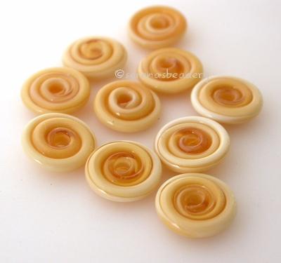 Honey Crunch Wavy Disk Spacer 10 wavy disks in honey crunch, an odd lot of glass2 sizes available: 11-12 mm with 1.5 mm hole or 13-14 mm with 2.5 mm holeprice is per 10 disks 11-12 mm 1.5 mm hole,12-13 mm 2.5 mm hole
