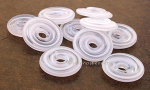 White Ribbon Tumbled Wavy Disk Spacer 10 tumbled wavy disks in white ribbon2 sizes available: 11-12 mm with 1.5 mm hole or 13-14 mm with 2.5 mm holeprice is per 10 disks 11-12 mm 1.5 mm hole,12-13 mm 2.5 mm hole