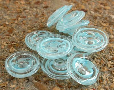 Turquoise Ribbon Wavy Disk Spacer 10 wavy disks in turquoise ribbon2 sizes available: 11-12 mm with 1.5 mm hole or 13-14 mm with 2.5 mm holeprice is per 10 disks 11-12 mm 1.5 mm hole,12-13 mm 2.5 mm hole