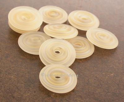 Ivory Ribbon Matte Wavy Disk Spacer 10 wavy disks in ivory ribbon in a matte finish2 sizes available: 11-12 mm with 1.5 mm hole or 13-14 mm with 2.5 mm holeprice is per 10 disks 11-12 mm 1.5 mm hole,12-13 mm 2.5 mm hole