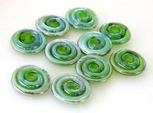 Green Lustre Wavy Disk Spacer 10 wavy disks in green lustre2 sizes available: 11-12 mm with 1.5 mm hole or 13-14 mm with 2.5 mm holeprice is per 10 disks 11-12 mm 1.5 mm hole,12-13 mm 2.5 mm hole