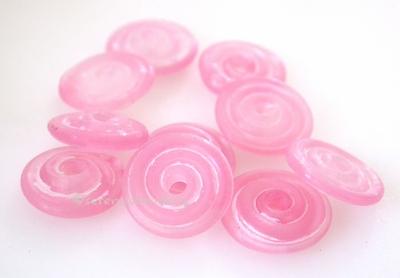 Clear and Pink Matte Wavy Disk Spacer 10 wavy disks in clear and pink in a matte finish2 sizes available: 11-12 mm with 1.5 mm hole or 13-14 mm with 2.5 mm holeprice is per 10 disks 11-12 mm 1.5 mm hole,12-13 mm 2.5 mm hole