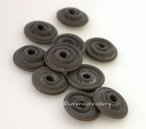 Adamantium Grey Matte Wavy Disk Spacer 10 wavy disks in adamantium grey in a matte finish2 sizes available: 11-12 mm with 1.5 mm hole or 13-14 mm with 2.5 mm holeprice is per 10 disks 11-12 mm 1.5 mm hole,12-13 mm 2.5 mm hole