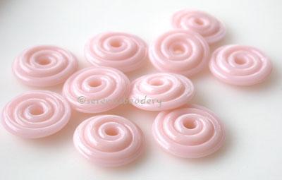 Desert Pink Wavy Disk Spacer 10 wavy disks in desert pink2 sizes available: 11-12 mm with 1.5 mm hole or 13-14 mm with 2.5 mm holeprice is per 10 disks 11-12 mm 1.5 mm hole,12-13 mm 2.5 mm hole