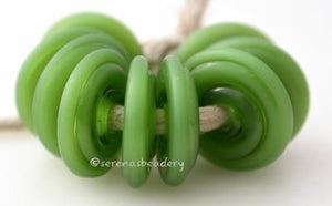 Mystic Green Tumbled Wavy Disk Spacer 10 tumbled wavy disks in mystic green2 sizes available: 11-12 mm with 1.5 mm hole or 13-14 mm with 2.5 mm holeprice is per 10 disks 11-12 mm 1.5 mm hole,12-13 mm 2.5 mm hole