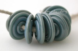 Sterling Blue Wavy Disk Spacer 10 wavy disks in sterling blue, a special production color2 sizes available: 11-12 mm with 1.5 mm hole or 13-14 mm with 2.5 mm holeprice is per 10 disks 11-12 mm 1.5 mm hole,12-13 mm 2.5 mm hole