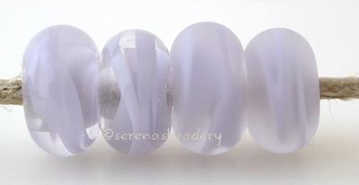 Lilac Ribbon Odd Color Notes: an odd lot of lilac ribbon cased in clear 5x10 mm Available shapes and sizes:Round Bead Shapes: Available to order 8 to 15 mm with hole sizes ranging from 1.5 to 5 mm. See drop down menu for the exact options. Shown here in 8, 9 and 10 mm with both a 2.5 mm and 1.5 mm hole. 4 and 5 mm holes will fit European Charm style jewelry.Also available in a wavy disk or bead cap:. Pressed bead shapes:Lentil - 12x13 mm in size with a 1.5mm hole.: Pillow 13 mm square with a 1.5 mm hole.: T