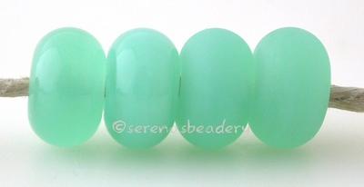 Sea Foam Limited Run Color Notes: An opal green resembling beach glass. Available shapes and sizes: Round Bead Shapes: Available to order 8 to 15 mm with hole sizes ranging from 1.5 to 5 mm. See drop down menu for the exact options. Shown here in 8, 9 and 10 mm with both a 2.5 mm and 1.5 mm hole. 4 and 5 mm holes will fit European Charm style jewelry. Also available in a wavy disk or bead cap: .   Pressed bead shapes: Lentil - 12x13 mm in size with a 1.5mm hole.:   Pillow 13 mm square with a 1.5 mm hole.