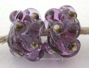 Lavender Silvered Ivory Wovens a pair of wovens with silvered ivory as a base and matching dots - shown here in dark lavenderThese woven beads are a very intricate and unique design with lots of texture. These are all one color for plenty of sparkle.7x13 mm Glossy,Matte