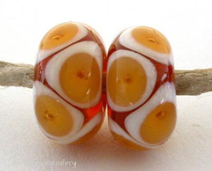 Amber Ivory Bubbles transparent amber and ivory offset bubbles. 7x12 mm 2.5 mm hole All of my lampwork glass beads are individually handmade using Effetre, Vetrofond, or Lauscha, Reichenbach, Double Helix, and Bullseye glass rods. They are annealed in a digitally controlled kiln for everlasting strength and durability.   Default Title
