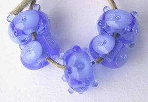 Very Blue Bubbles a set of 5 with bubbles in a variety of designs 6x12mm 2.5 mm hole price is per set of 5 beads All of my lampwork glass beads are individually handmade using Effetre, Vetrofond, or Lauscha, Reichenbach, Double Helix, and Bullseye glass rods. They are annealed in a digitally controlled kiln for everlasting strength and durability. Default Title