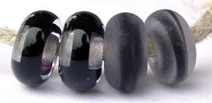Black Ribbon Color Notes: black ribbon cased in clear 5x10 mm Donut- This is my basic spacer size. It is made on a 3/32 mandrel with a 2.5 mm hole. Other available sizes and shapes: 4x8 mm Round- A miniature sized spacer with a 1.5 mm hole. Lentil- 12x13 mm in size with a 1.5mm hole. Pillow- 14 mm square with a 1.5 mm hole. Disk- 3x13 mm with a 2.5 mm hole. Also 6x12 mm donut- A larger donut with a 2.5 mm hole. 8x15 mm Super Sized- A humungous spacer with a 3.5 mm hole. It is perfect for stringing on leathe