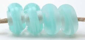 Light Turquoise Ribbon Color Notes: light turquoise ribbon cased in clear 5x10 mm Available shapes and sizes:Round Bead Shapes: Available to order 8 to 15 mm with hole sizes ranging from 1.5 to 5 mm. See drop down menu for the exact options. Shown here in 8, 9 and 10 mm with both a 2.5 mm and 1.5 mm hole. 4 and 5 mm holes will fit European Charm style jewelry.Also available in a wavy disk or bead cap:. Pressed bead shapes:Lentil - 12x13 mm in size with a 1.5mm hole.: Pillow 13 mm square with a 1.5 mm hole.: